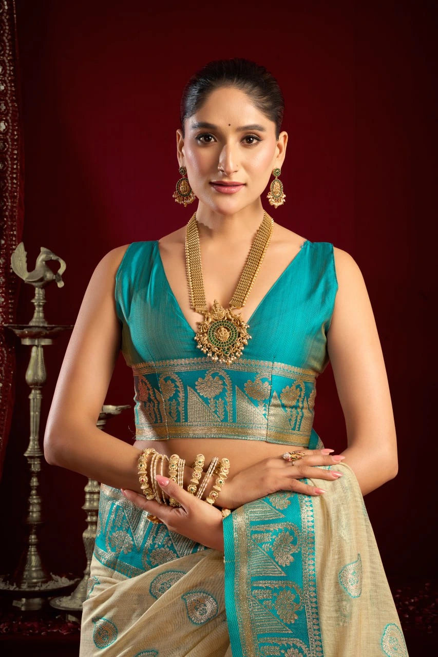 Woman in traditional attire with jewelry against a dark background
